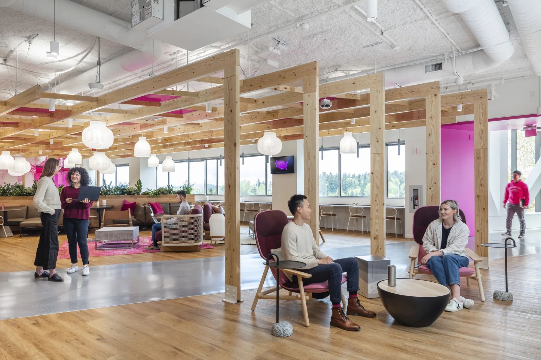 Modern office space with employees and real estate executives talking about the leader in space management software, Wisp. 