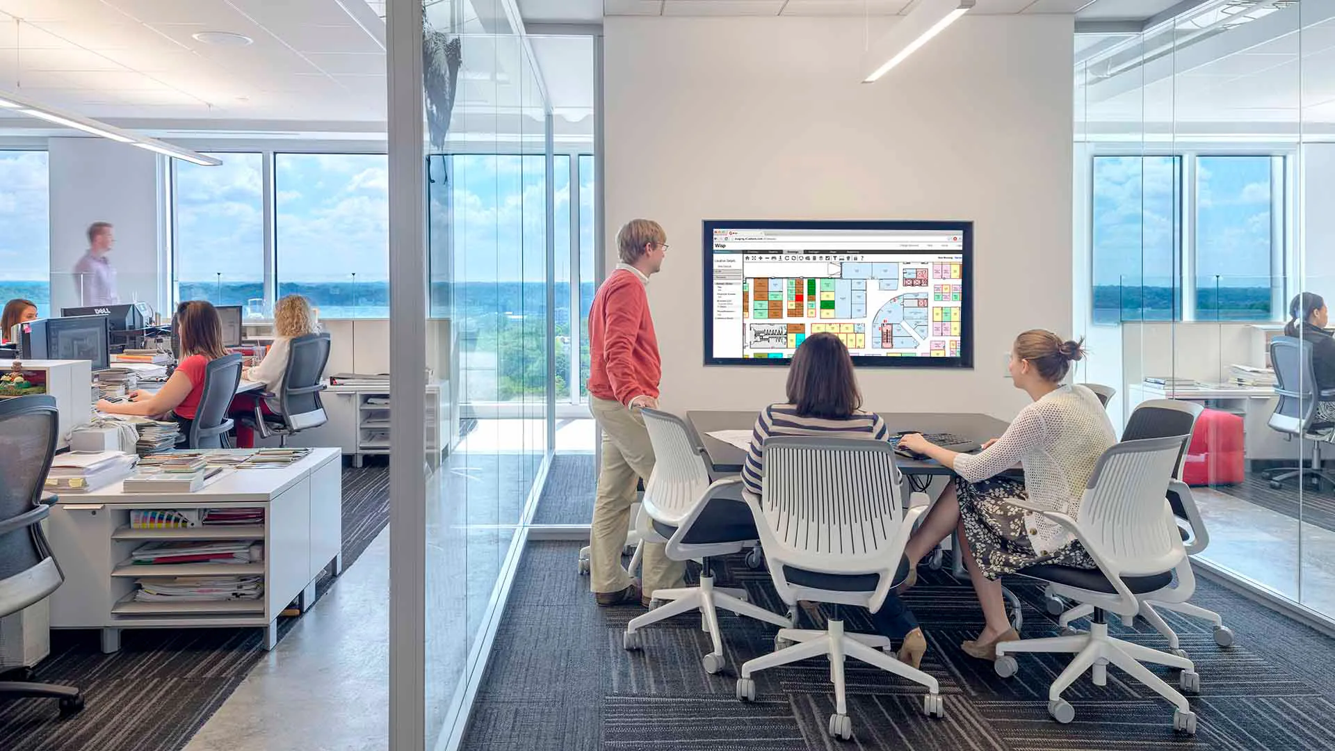 Facility managers and corporate real estate executives working together on occupancy ratios and floor plan updates utilizing Wisp's space management software.